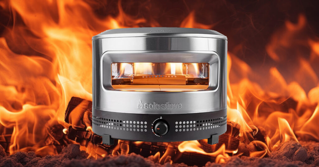 Solo Stove pizza oven in front of flames