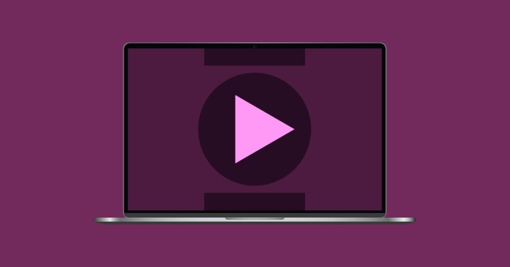 Laptop with a play button and abstract shapes