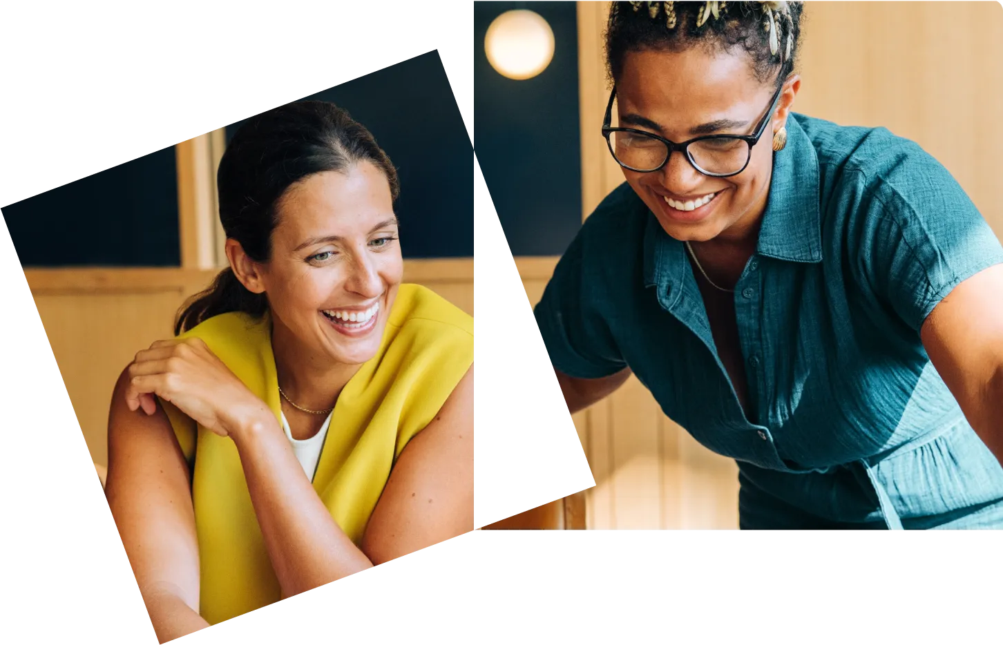Two women smiling and looking at a screen