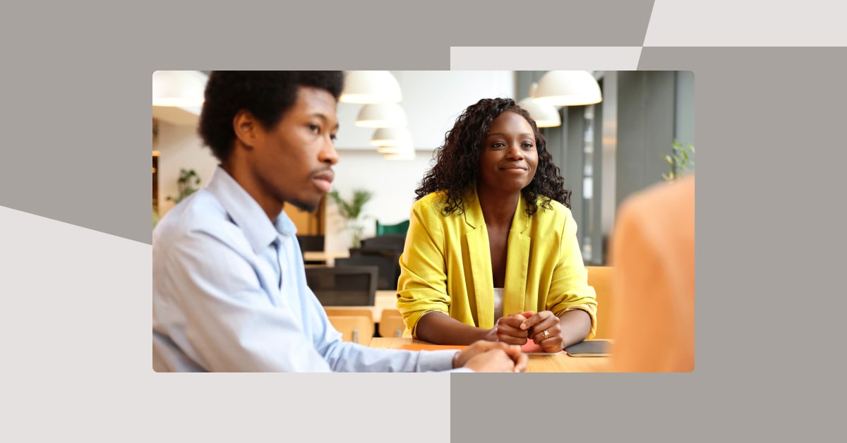 two people in an office in discussion on abstract background