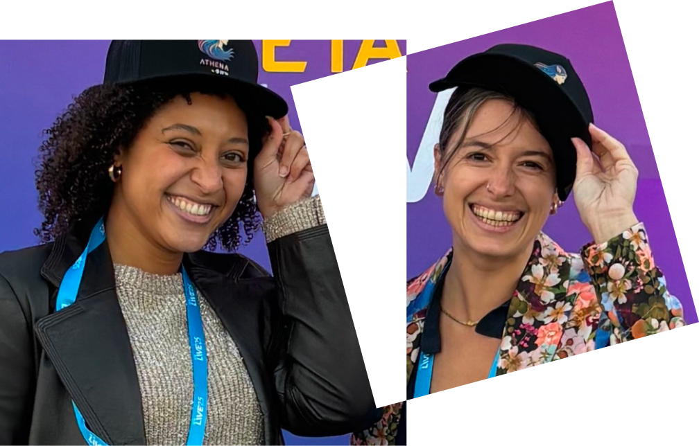 Two women wearing fun hats at a party and smiling