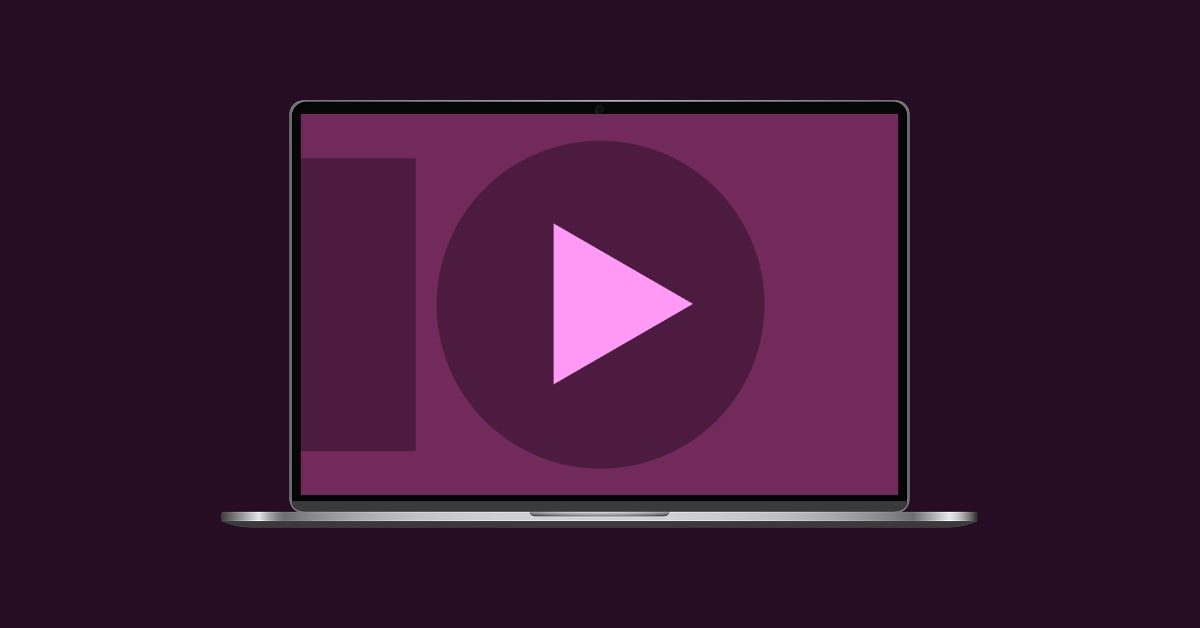 Laptop with a play button and abstract shapes