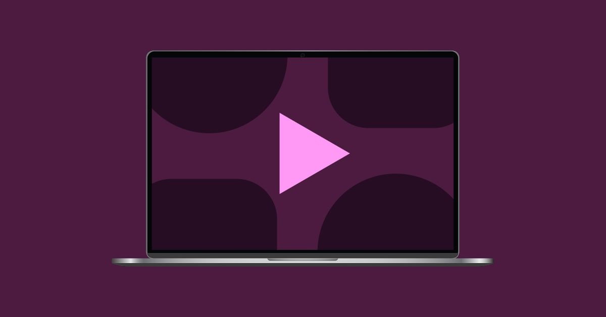 Laptop with a play button and abstract shapes