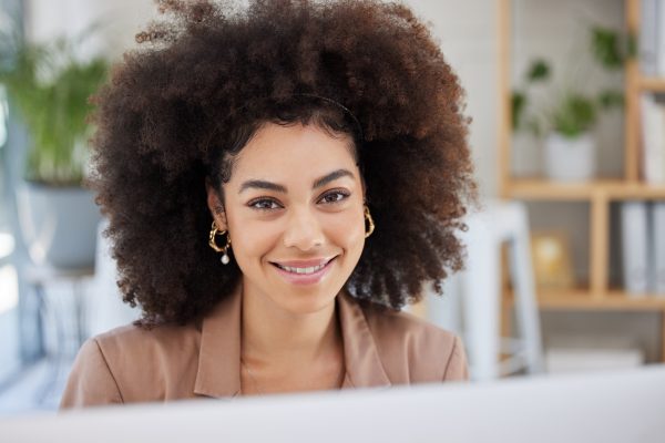Woman smiling at a computer
