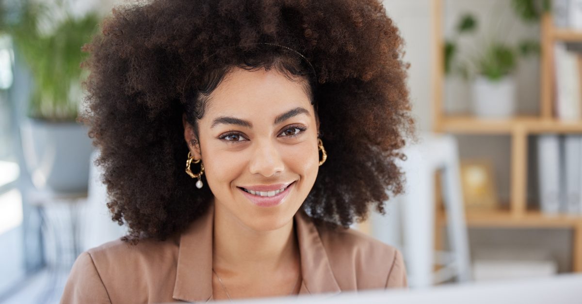 Woman smiling at a computer