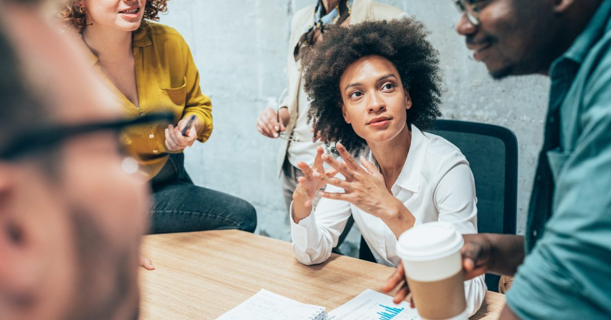 Woman listening to a proposal, looking thoughtful.