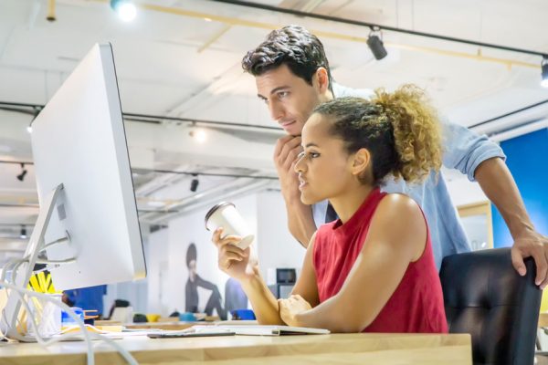 man and woman working at desk