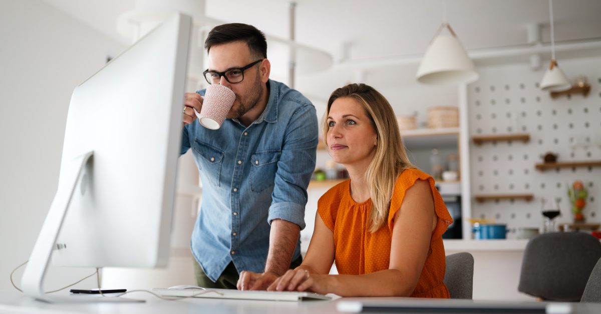 two creative businesspeople looking at a computer screen