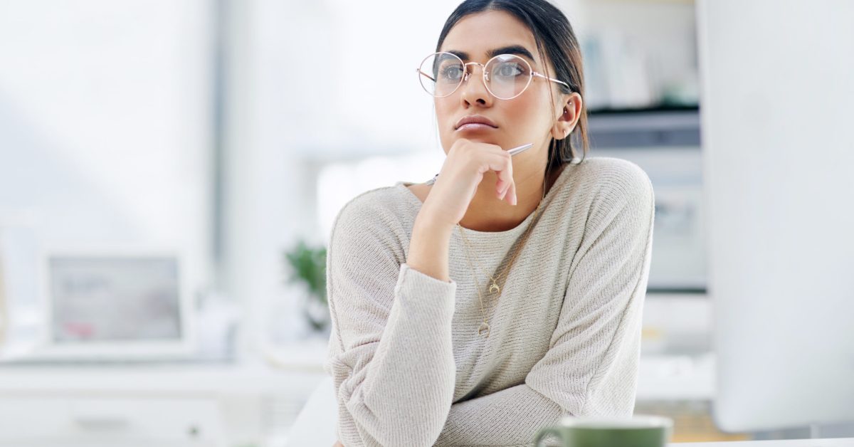 Shot of a young businesswoman looking thoughtful while working in an office.