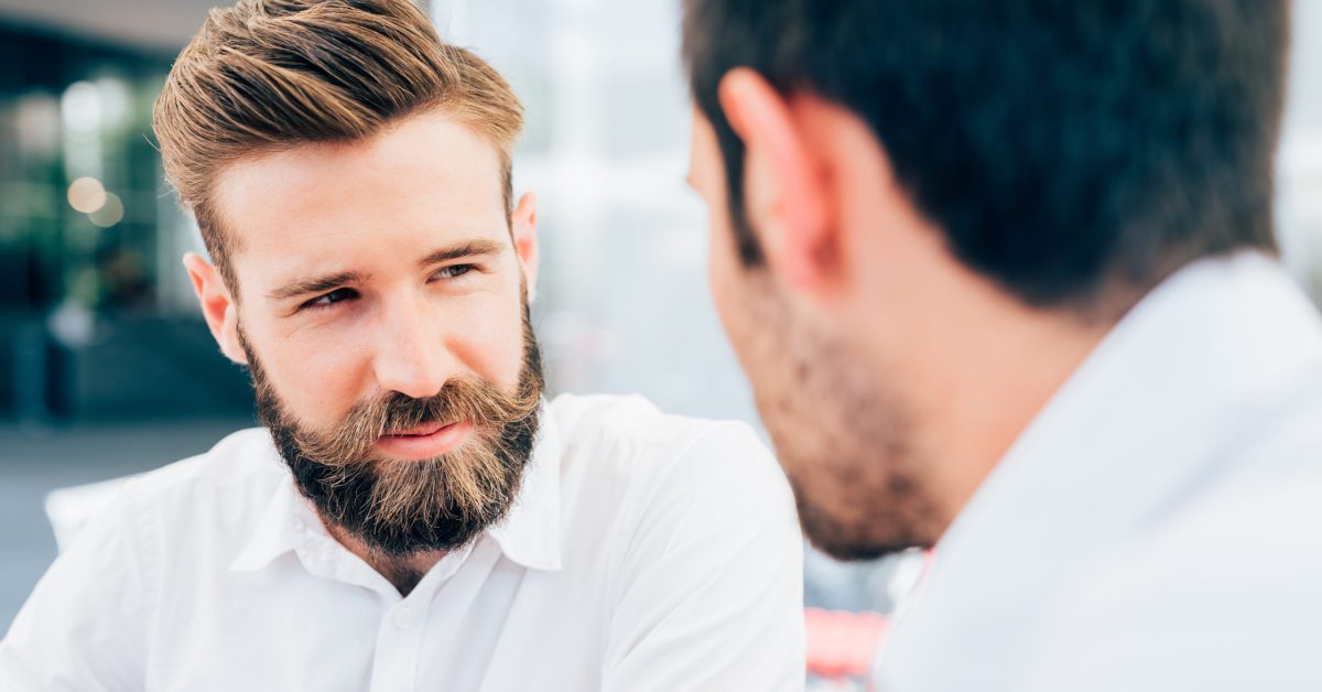 Portrait of young beautiful caucasain bearded man talking with a colleague - business, entrepreneur, interaction concept