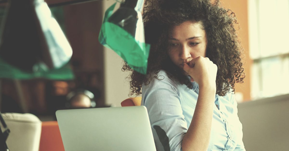 woman email marketer at computer thinking of CTAs