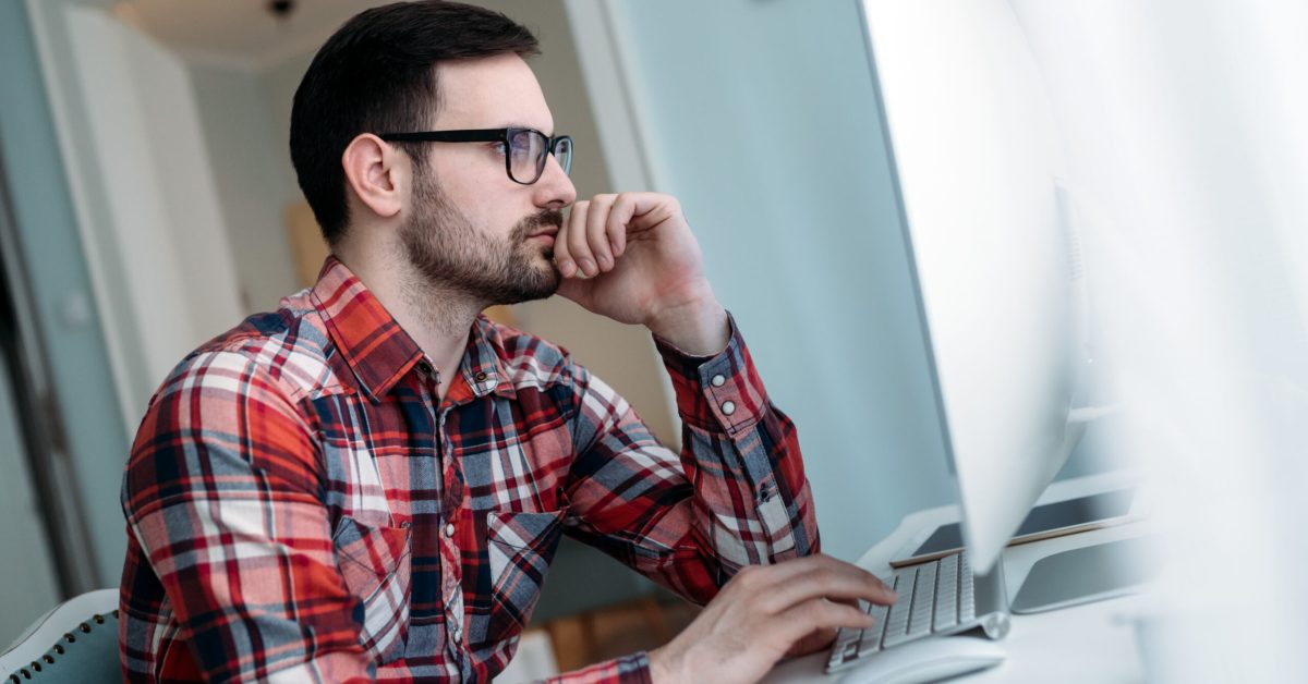 Young attractive designer working on project at home